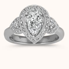 a pear shaped diamond ring with diamonds around it