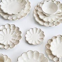 several white dishes are arranged on a table