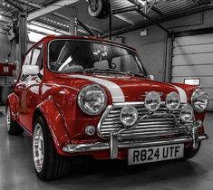 an old red car parked in a garage