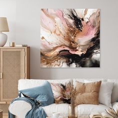 a living room with white couches and paintings on the wall above them in neutral colors