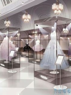 a display case filled with wedding gowns and chandeliers