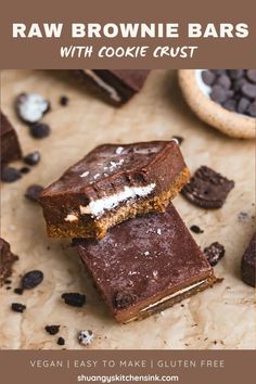 raw brownie bars with cookie crust are on a table next to some chocolate chips