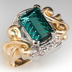 This striking ring is centered with one (1) rectangular cushion step cut natural tourmaline set into a four-prong setting. The center stone is bordered to the north and south with three (3), prong set, round brilliant cut diamonds. The ring measures 16.7mm at the top, rises 7.7mm above the finger, tapering to 2.6mm wide and 0.8mm thick at the base of the shank. This ring is currently a size 6.25. Elegant Rectangular Tourmaline Ring, Antique Cocktail Ring, Brilliant Diamond, Round Brilliant Cut Diamond, High Quality Jewelry, Brilliant Cut Diamond, Cocktail Rings, Estate Jewelry, Prong Setting