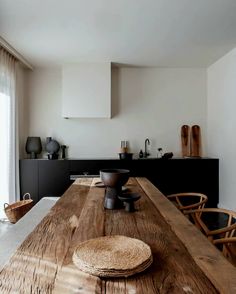 a large wooden table sitting in the middle of a kitchen