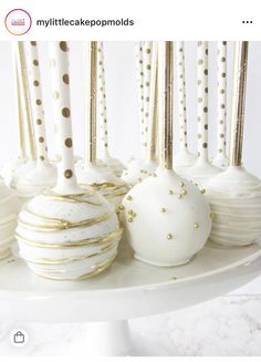 white cake pops with gold sprinkles are on a plate next to each other