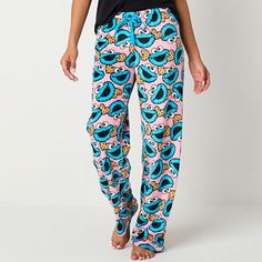 Get cozy on cool nights wearing these fun Sesame Street women's and junior's fleece pajama pants. They're decked out in a bright multicolor pattern featuring the Cookie Monster and include an adjustable elastic-drawstring waist for added comfort. Wear them with a PJ top and fluffy slippers.Features: Adjustable WaistCharacter: Sesame StreetClosure Type: Full Elastic, DrawstringApparel Length: 41 InchesFiber Content: 100% PolyesterFabric Description: MicrofleeceInseam: 31 InCare: Machine Wash, Tum Elmo Pants, Cookie Monster Pants, Cookie Monster Pajamas, The Cookie Monster, Fleece Pajama Pants, Fluffy Slippers, Womens Pajamas Pants, Comfort Wear, Cookie Monster