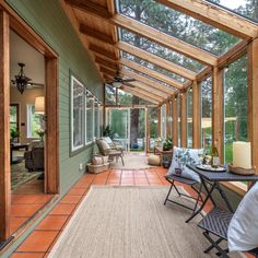 a covered porch with chairs and tables on it