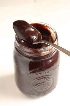 a spoon is in a jar filled with chocolate