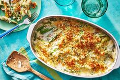 a casserole dish with broccoli, cheese and bread crumbs