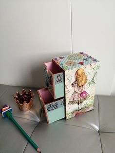 a little box that is sitting next to a toothbrush and some other things on the table