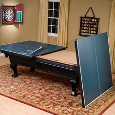 a ping pong table in the middle of a room with a rug on the floor