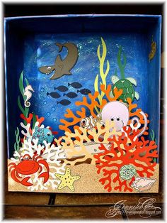 an ocean scene made out of cardboard with sea animals, fish and corals in it