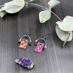 These earrings are so fun! The 13x20.5mm glass charms are super glowy and shift between pink, purple, and gold. I paired them with my hand forged sterling silver curved bars, 3.5mm faceted elongated black spinel, 3mm faceted apatite, 2mm faceted apatite, and 2mm faceted tanzanite.These earrings are sterling silver with 20 gauge earwires.Each earring is just under 2” long and weighs 2.4 grams. Nickel Free Pink Copper Earrings, Nickel-free Pink Copper Earrings, Handmade Pink Sterling Silver Hoop Earrings, Unique Pink Sterling Silver Earrings, Unique Nickel-free Pink Earrings, Unique Nickel Free Pink Earrings, Unique Pink Jewelry For Everyday, Unique Pink Everyday Jewelry, Glass Charms