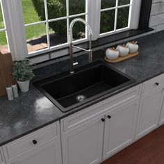 a black kitchen sink sitting under a window