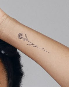 a woman with a rose tattoo on her arm