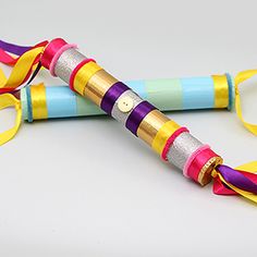 an umbrella made out of colored paper and ribbon