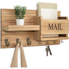 a wooden shelf with hooks and a potted plant on it that says mail hanging from the wall