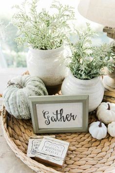 a basket filled with potted plants on top of a wooden table next to a sign