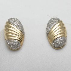 "This is a stunning pair of vintage diamond earrings! These earrings are made of 14k yellow and white gold. They are stud earrings that are oval in shape and mostly yellow gold with a beautiful groove swirly design on the yellow gold part. The top and bottom of each earring is filled with pave set diamonds. The are very nice quality diamonds, white and sparkly, G-H in color and VS2-SI1 in clarity. The total carat weight is approximately 0.80 carats. They are posts with nut backings for pierced e Gold Oval Diamond Earrings, Oval Earrings With Pave Setting For Anniversary, Classic Oval Diamond Earrings With Pave Setting, Oval Diamond Earrings With Pave Setting For Anniversary, Gold Oval Diamond Earrings With Accents, Oval Diamond Earrings With 14k Gold Accents, Oval 14k Gold Diamond Earrings With Accents, Vintage Diamond Earrings, Swirly Designs