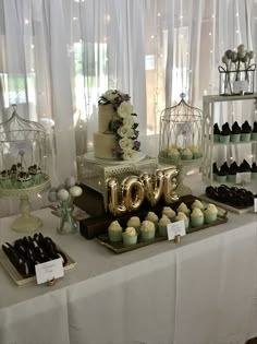 a table topped with lots of cakes and cupcakes