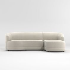 a white couch sitting on top of a white floor