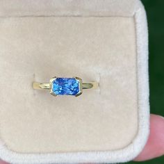 a ring with a blue stone in it