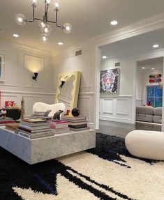 a living room filled with lots of furniture and decor on top of a black rug