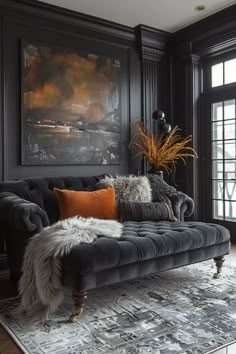 a living room filled with furniture and a large painting on the wall above it's windows