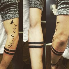 two men's legs with birds on them, one has a black strip around the leg