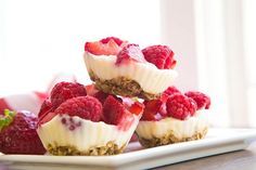 small desserts with raspberries and granola on a plate