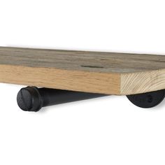 a wooden shelf with black wheels on a white background