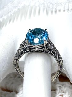 Natural Blue Topaz Sterling Silver RingMedieval Floral Design#D173 Introducing the D173 Medieval Floral ring! A gorgeous antique reproduction crafted to resemble its classic predecessors, while still boasting a modern touch. This enchanting piece of jewelry features an oval faceted gemstone, which has been prong set over stunning filigree, complete with intertwined floral designs and vine imagery that dance down the sides of the band. Thanks to this subtle balance of influences from both Art Dec Blue Topaz Ring Gold, Floral Filigree, Nature Ring, Floral Ring, 14k White Gold Ring, Engraved Items, Blue Topaz Ring, Topaz Ring, Silver Rose Gold