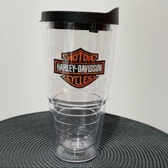 a harley davidson logo tumbler sitting on top of a table