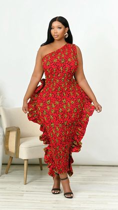 Step into elegance with this captivating one-shoulder ruffled midi dress. Crafted in a vibrant African-inspired red and yellow print, this dress effortlessly combines tradition and modernity. The smocked bodice hugs your curves comfortably, while the delicate ruffle accents add a touch of drama and flair. Perfect for weddings, parties, or any festive occasion, this dress is designed to turn heads. Pair it with bold accessories and strappy heels to complete your stunning look. Features Stretch Ru Multicolor One-shoulder Ruffle Dress, Red Ruched Dress With Asymmetrical Neckline, Red Floral Print Off-shoulder Maxi Dress, Red Off-shoulder Maxi Dress With Floral Print, Red Strapless Maxi Dress With Ruffles, Red One-shoulder Maxi Dress For Spring, Ruffled Midi Dress, One Shoulder Maxi Dress, Mini Dress Formal