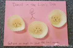 two paper cups with faces drawn on them and the words dance in the lion's den