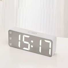 an alarm clock sitting on top of a table