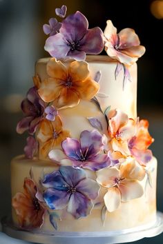 a three tiered cake with flowers on it