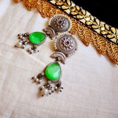 These Ethnic Indian Earrings Are Made Of High-Quality Metal And Are Perfect For Adding A Touch Of Elegance To Any Outfit. The Earrings Feature A Beautiful Green Drop Design That Is Sure To Catch The Eye, And They Are Lightweight And Comfortable To Wear. Whether You're Attending A Wedding Or A Party, These Earrings Are A Great Way To Dress Up Your Look. Traditional Green Metal Earrings, Festive Green Bohemian Earrings, Green Bohemian Dangle Jhumkas, Handmade Green Bohemian Jhumkas, Green Bohemian Chandbali Danglers, Bohemian Green Chandbali Danglers, Bohemian Drop Earrings For Festive Season, Festive Bohemian Drop Earrings, Drop Design