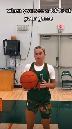 a woman holding a basketball while standing in a gym with the caption, when you see a 10 / 10 at your game