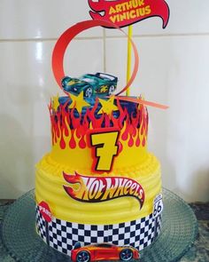 a birthday cake with hot wheels on top