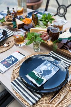 the table is set with plates, napkins and other things to eat on it