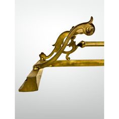 an antique brass coat rack with two birds on it