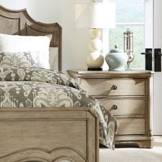 a bedroom scene with focus on the bed and nightstands, which are decorated in neutral tones