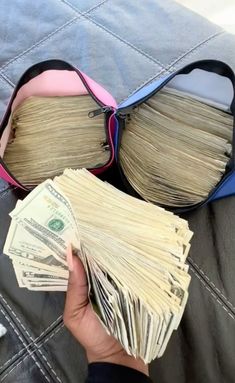 a person is holding money in their purse