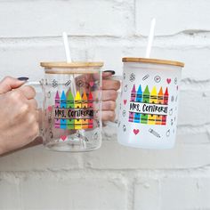 two people holding coffee mugs with colored crayons and the words miss confection on them