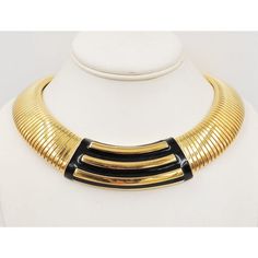 This is part of Chairish’s Costume Jewelry assortment.  1980s wide goldtone black enamel collar necklace with snap closure. Marked "Monet." Measures:  6 7/8 inches long by 6 7/8 inches wide. Center; 1 inch. Condition: Very good; minor wear.   Please reference the measurements noted in the description above for the best approximate dimensions. Please reach out to the seller under "Ask the Seller" for specific questions regarding the measurements. 70’s Jewelry Necklace, Monet Costume Jewelry, Black Choker, Modern Branding, Accessories Jewelry Necklace, Collar Necklace, Black Enamel, Costume Jewelry, Snap Closure