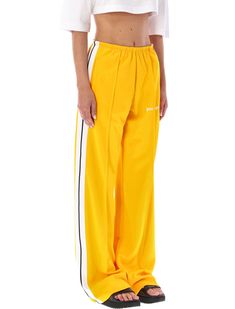 Loose Track Pants By Palm Angels. Featuring: Elasticated Waistband Side Slit Pockets Contrast Band Along Each Side Loose FitComposition: 100% polyester | Palm Angels Women's Loose Track Pants in Yellow | FW22/23 Urban Chic, Palm Angels, Diaper Backpack, Luxury Retail, Womens Backpack, Short Pants, Track Pants, Pajama Pants, Designer Dresses