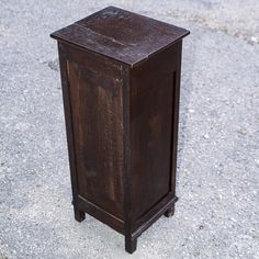 an old wooden cabinet sitting on the ground