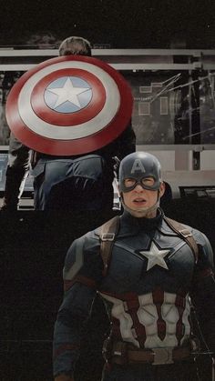 captain america is standing in front of some people