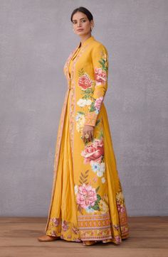 Editor's Note Featuring Sunehra Dhuni Jaquard Chogha With Sunehra Rati Dress Color: Yellow Fabric: Jacquard, Pure Cotton Silk, Hand Woven Chanderi Components: Jacket and dress Care: Dry Clean Only About the Designer Torani by Karan Torani stands handcrafted luxury inspired by the myriad tales of Indian mythology. Torani is a potpourri of all things nostalgic that binds you with a memory long forgotten. The label works with and revives timeless Indian textiles and embroidery traditions. Dress With Long Jacket, Jacket With Dress, Jacket Dress Set, Embroidered Crop Tops, Jacquard Jacket, Draped Skirt, Yellow Print, Necklines For Dresses, Silk Organza